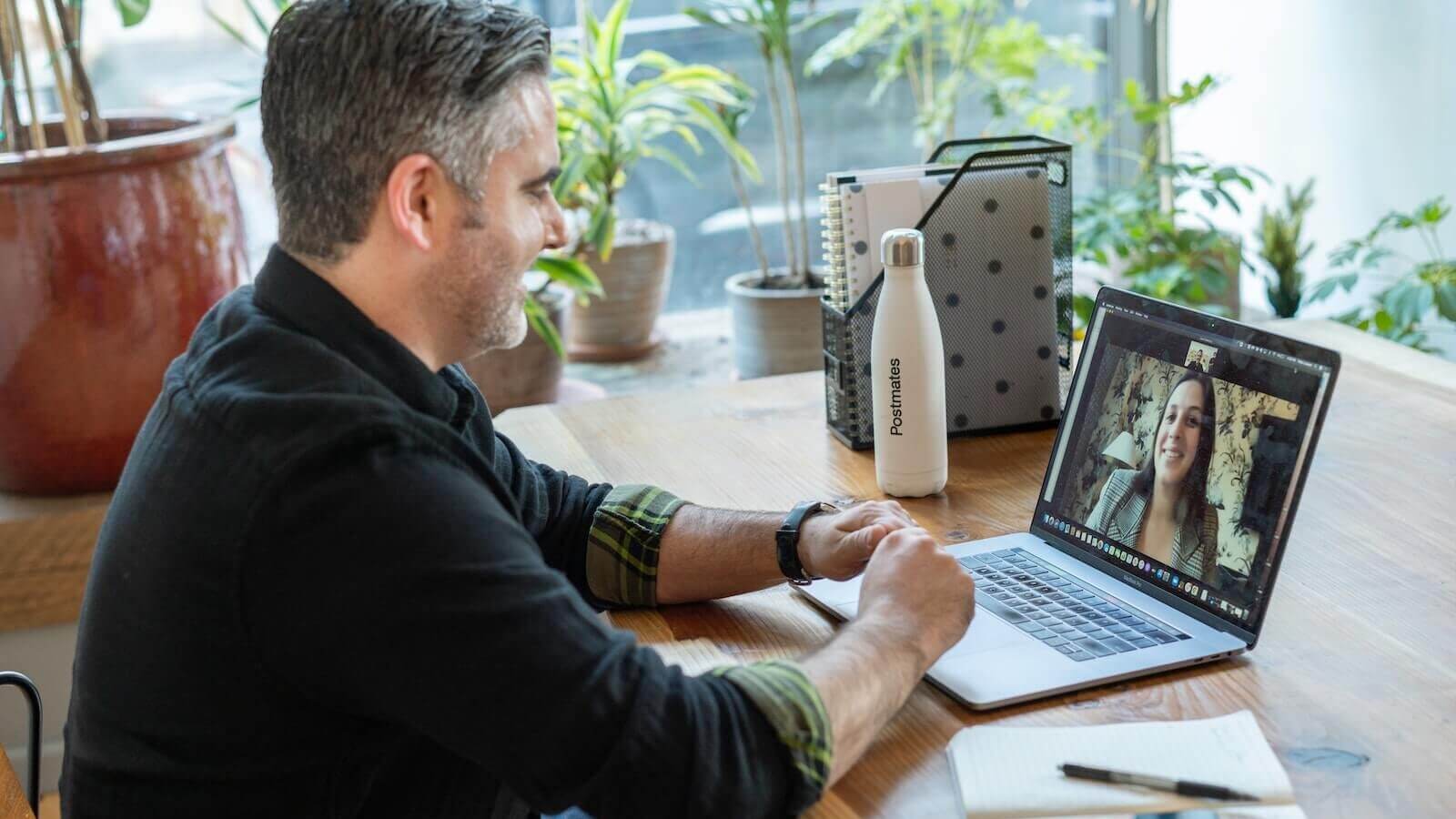 man in black sweater using macbook pro