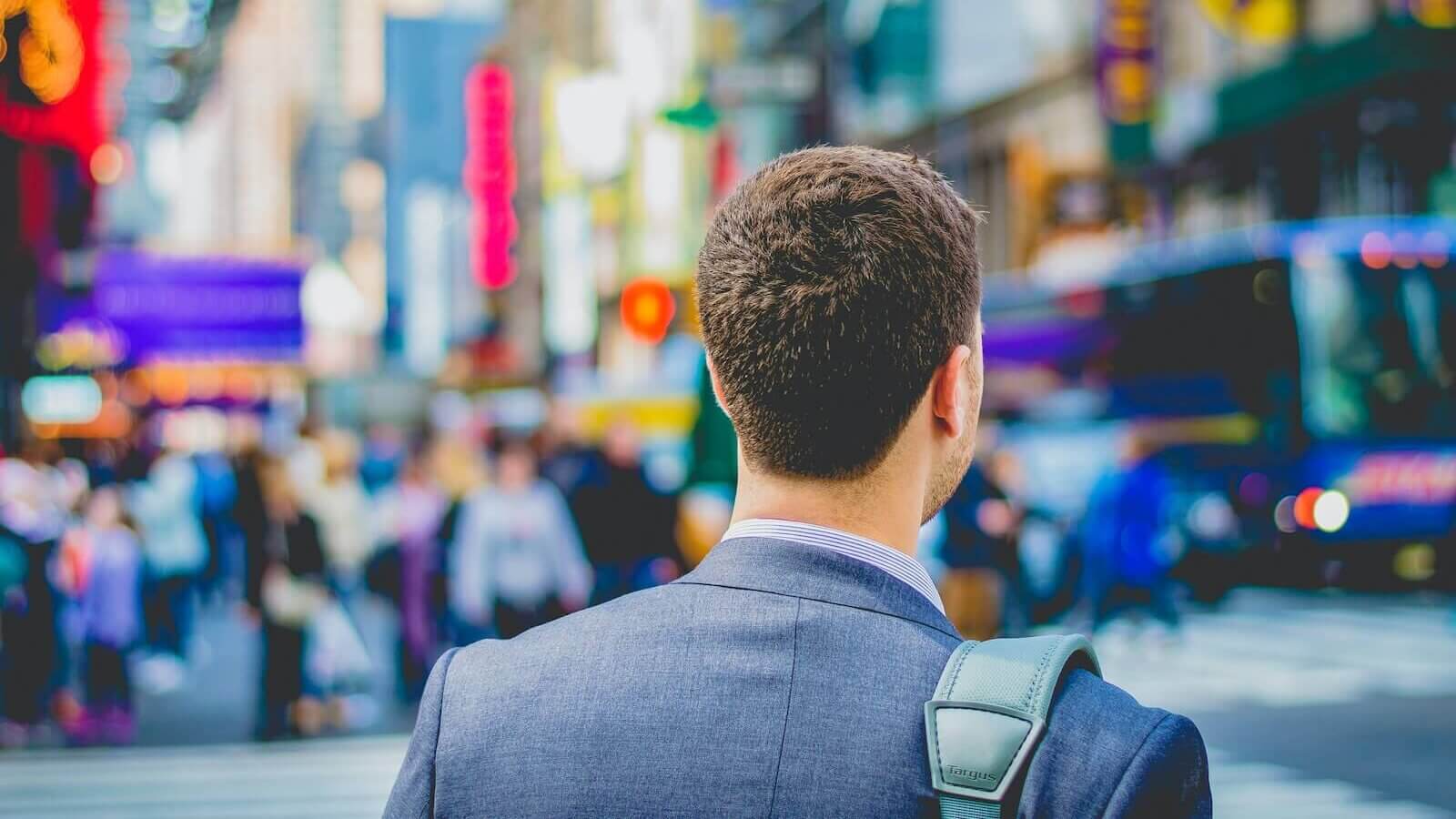 shallow focus photography of man in suit jacket's back